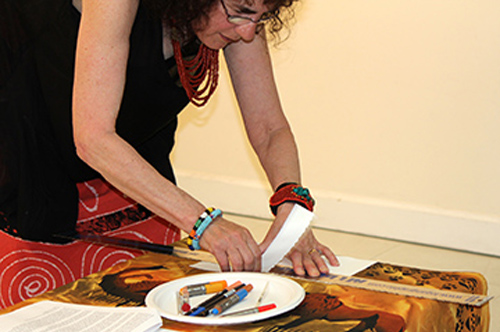 Marian Osher provides an artist's demonstration during the reception. Photo by Steve Raphael.